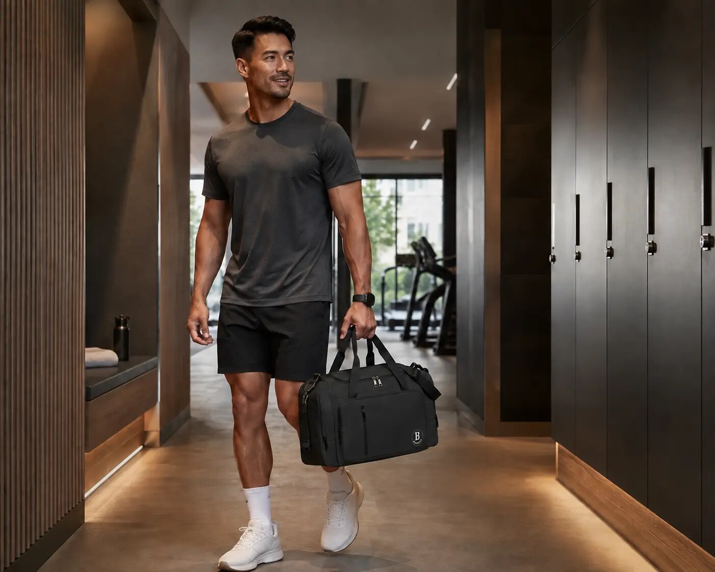 Athlete carrying a black Branvue bag through a gym